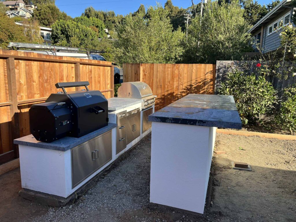 Outdoor cooking area with grill and prep counter