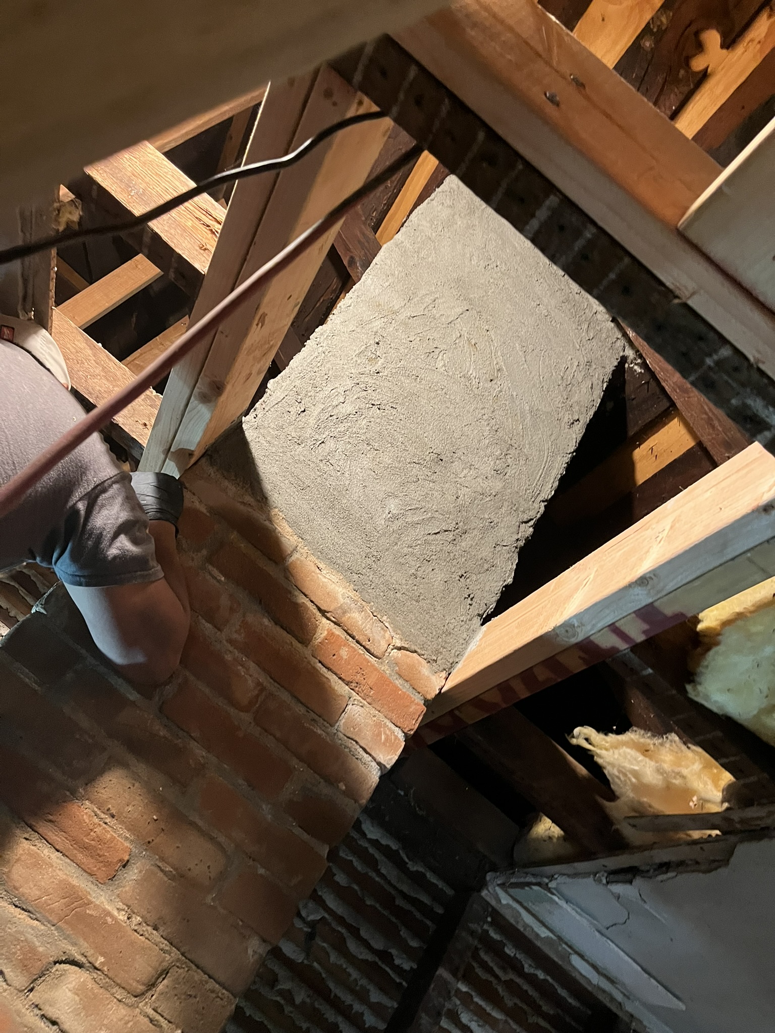 Sierra West Co. rebuilding and parging a chimney in a Petaluma attic space